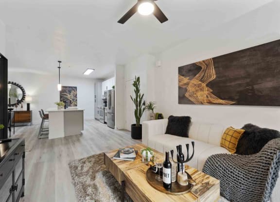 a living room with a white couch and a wooden coffee table on top of a furry rug