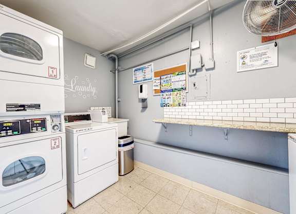 A laundry room with a washing machine and a dryer at Pennsylvania Place, Davis, CA