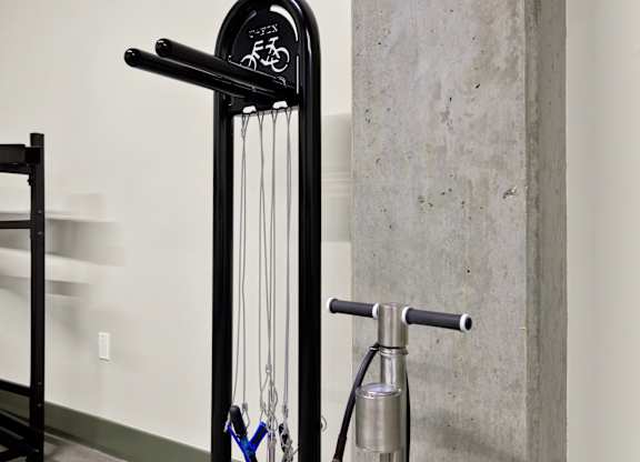 A black bike rack with a bike hanging on it at 26FIFTY Apartments, Berkeley 94704