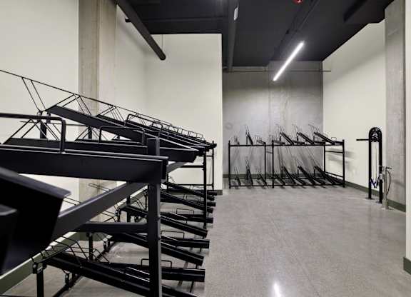 A room with a lot of black chairs and tables at 26FIFTY Apartments, Berkeley, CA
