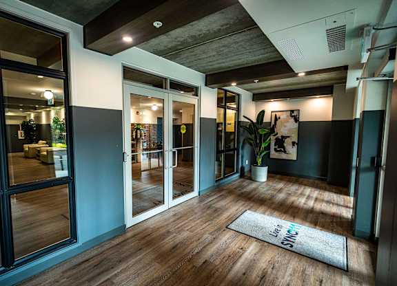 a living room with glass doors and a rug