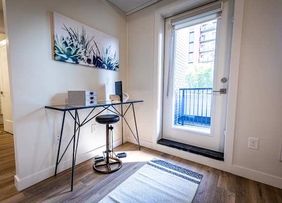 a living room with a glass table and a window