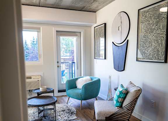 a living room with a couch and a chair and a table