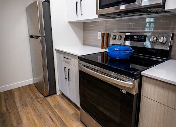 a kitchen with stainless steel appliances and white cabinets