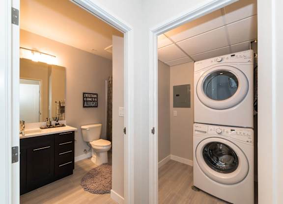 A white washer and dryer in a small laundry room.