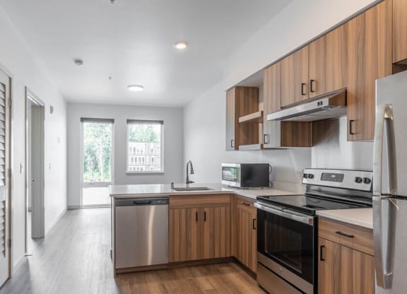 a kitchen with a stove top oven next to a refrigerator
