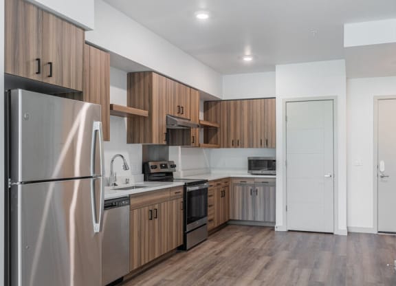 a kitchen with wooden cabinets and stainless steel appliances