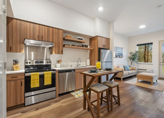 a kitchen and living room with a table and stools
