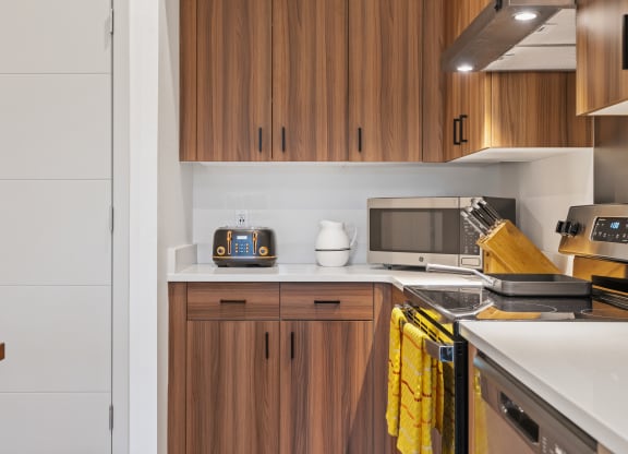 a kitchen with a stove top oven and a microwave