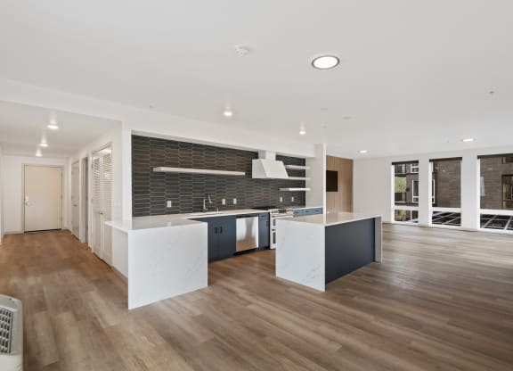 a large kitchen with white countertops and a black