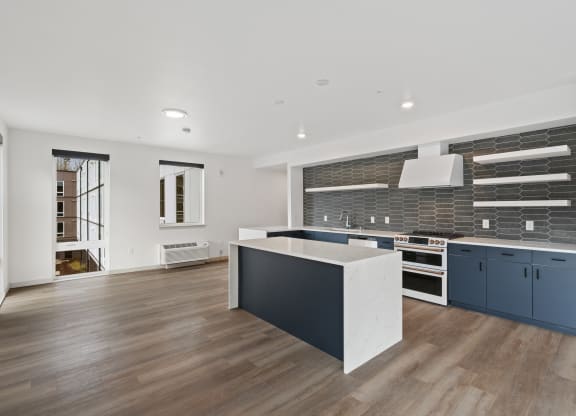 a large kitchen with blue cabinets and a white counter top