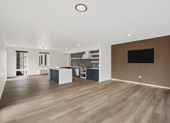 a living room with a kitchen and a tv