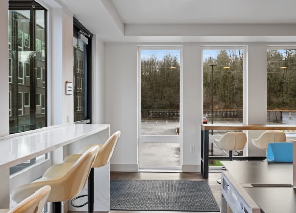 a living room with a table and chairs and sliding glass doors