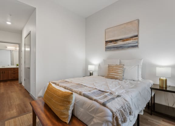 a bedroom with a large bed and a bathroom