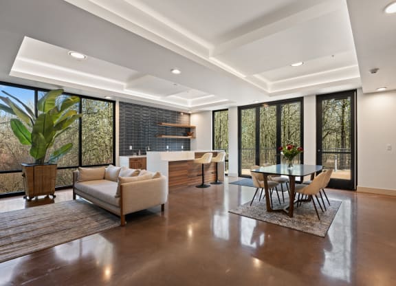 A large living room with a dining table and kitchen and couch