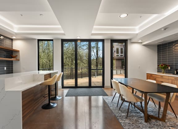 a large kitchen and dining area with a table and chairs and sliding glass doors
