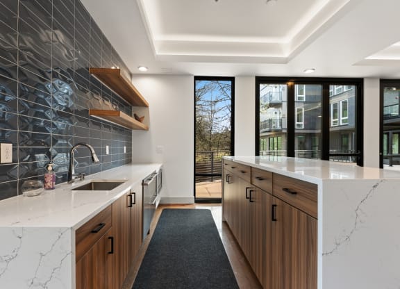 a large kitchen with marble counter tops and wooden cabinets