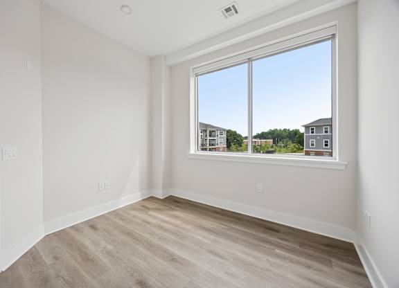 Sunlit Empty Room with Elegant Wooden Flooring at Heritage Court, Ewing, NJ