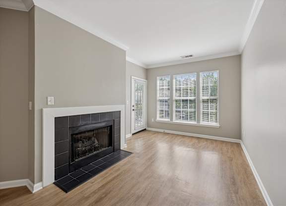 A room with a fireplace and a window.