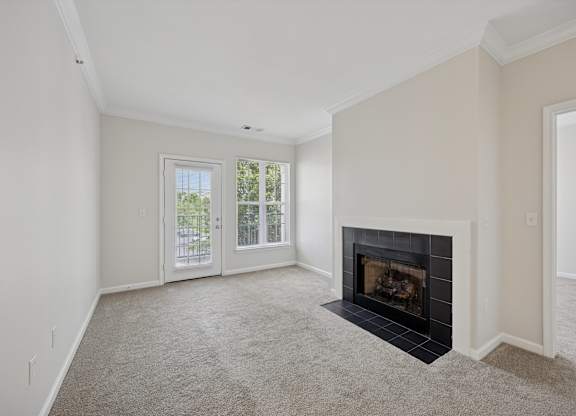 A living room with a fireplace and sliding glass doors.