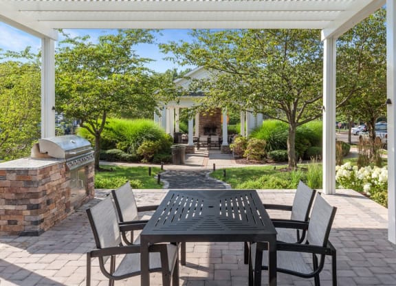 a patio with a table and chairs and a grill  at Harper's Crossing, Langhorne, 19047