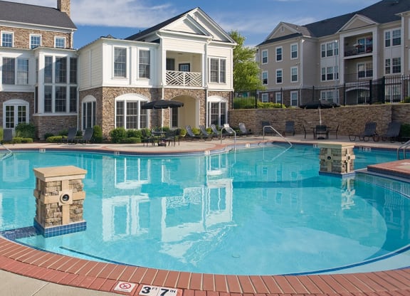 a swimming pool in front of an apartment building  at Harper's Crossing, Langhorne, PA, 19047