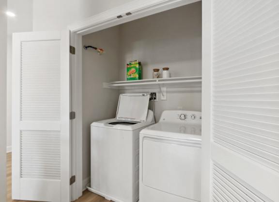 White Laundry Room with Shelves at Heritage Court, Ewing, NJ