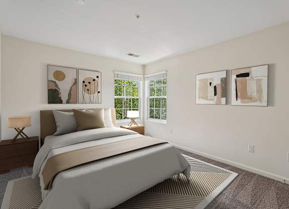 A bedroom with a large bed and two paintings on the wall.