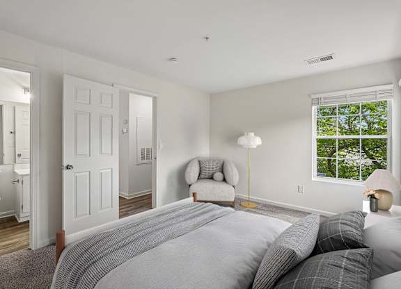 A bedroom with a large bed and a window.