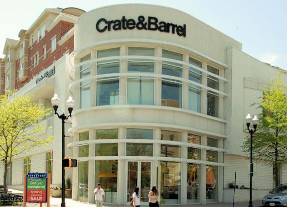 A Crate & Barrel store with two people standing in front.