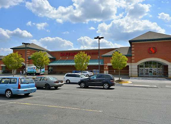 A parking lot in front of a Safeway store.