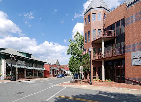 A street view of a town with a building that has the letters ACG on it.