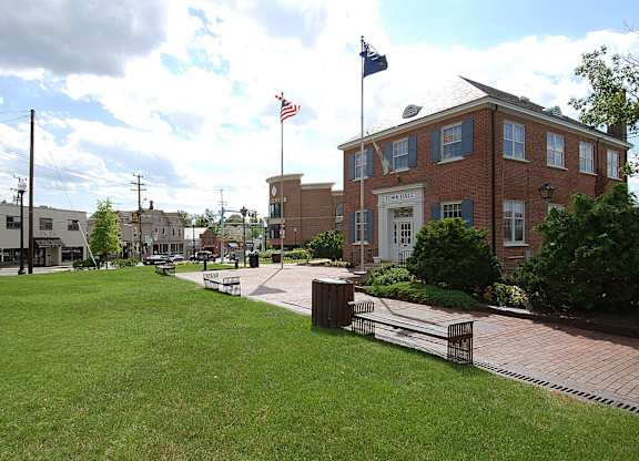 A large brick building with a flag on top of it.