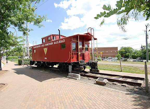 A red train car is parked on a track.