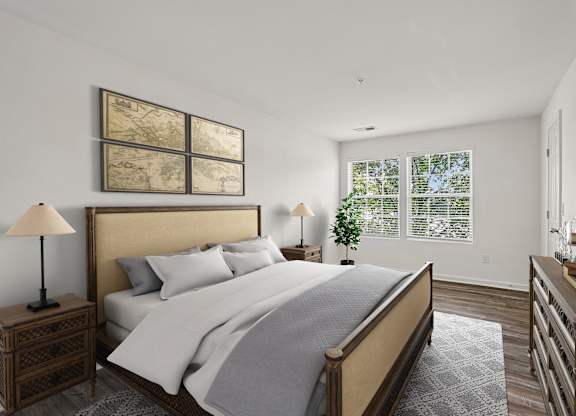 A bedroom with a large bed and a wooden nightstand.