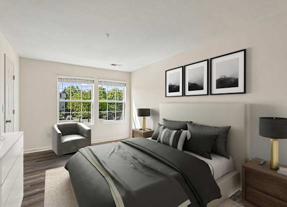 A bedroom with a large bed and a chair by the window.