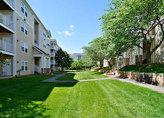 A sunny day at a grassy apartment complex.