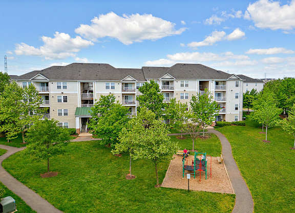 Apartment complex with a playground in the front.