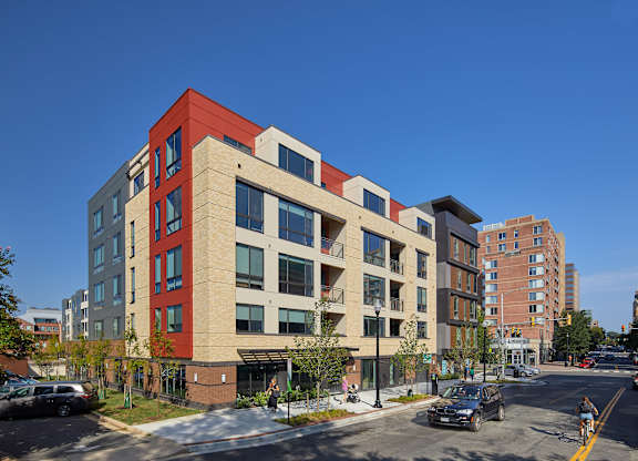 A red and beige building with a clear blue sky in the background.