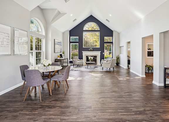 A dining room with a table and chairs.