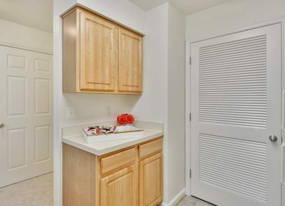 A kitchen with wooden cabinets and a white countertop.