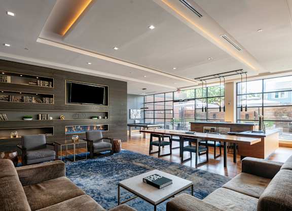 A modern living room with a fireplace and a large window.