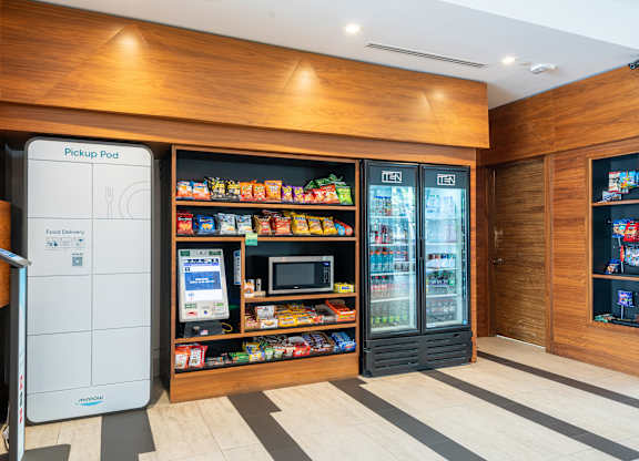 A modern kitchen with a white fridge and a wooden counter top.