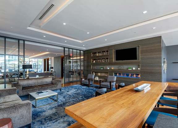 A modern living room with a wooden table and a television.