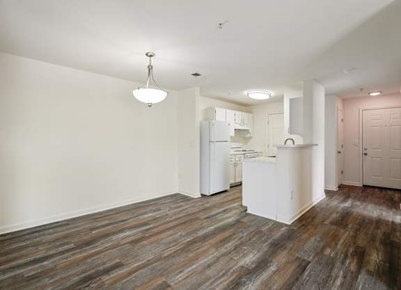 Open-concept dining and kitchen space, featuring recently updated flooring in select standard market apartment homes.