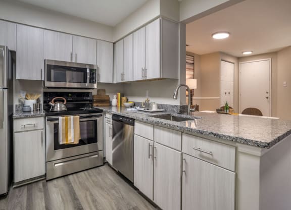 Renovated Kitchen with stainless steel appliances and granite countertops at Elme Manassas, Virginia