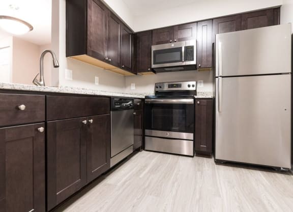 Kitchen with stainless steel appliances and granite countertops at Elme Manassas, Virginia