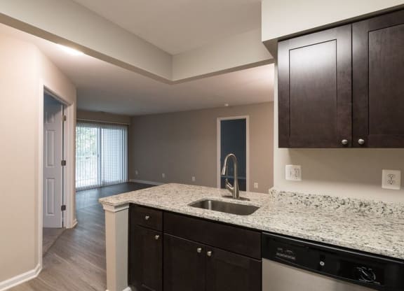 Kitchen with stainless steel appliances and granite countertops at Elme Manassas, Virginia