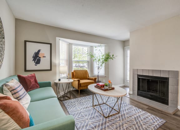 a living room with a blue couch and a coffee table at Elme Herndon, Herndon, Virginia 