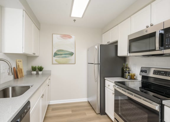 Renovated kitchen with stainless steel appliances and white cabinets  at Cascade at Landmark, Alexandria, 22304